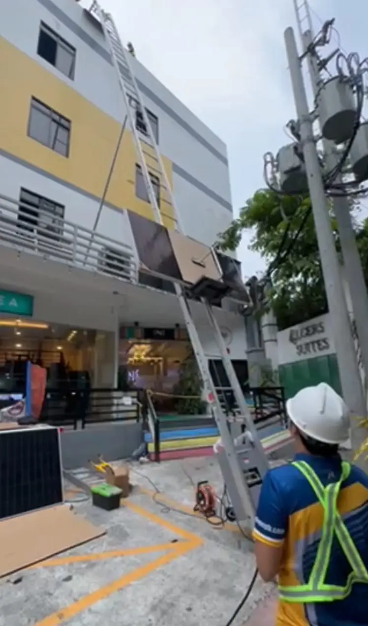 Customers in Metro Manila, Philippines, use Ladder Hoist to deliver photovoltaic panels to rooftops.jpg